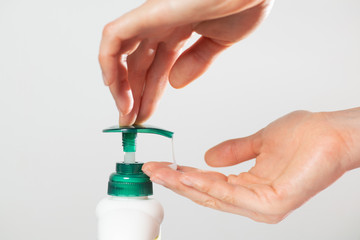 Woman using liquid soap dispenser for hand washing. Anti coronavirus hygiene