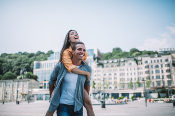 Happy loving couple walking in city and having fun