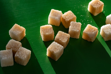 close up of sugar cubes on a green background