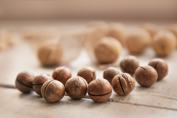 nuts in their shells on a white wooden background