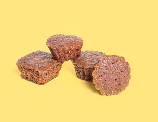 Composition of four cupcakes isolated on a yellow background