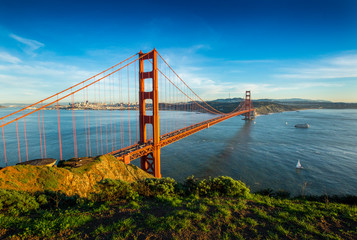 A sunny afternoon at the Golden Gate Bridge with the skyline of San Francisco, California in the background.