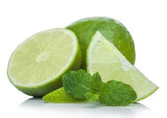 Fresh raw lime with mint leaf on white background with reflection.