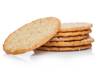 Stack of round organic crispy wheat  flatbread salty crackers on white.