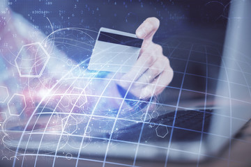Double exposure of man hands holding a credit card and world map drawing. International Internet E-commerce and technology concept.