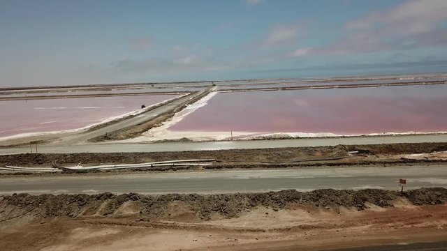 4K aerial drone video of salt works factory wide pink salty water evaporation ponds, in outskirts of coastal harbour town Walvis Bay, Namib Desert, Atlantic Ocean west coast, Namibia, southern Africa
