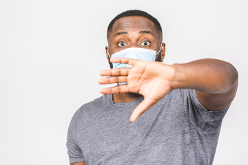 African american man with mask to protect him from Coronavirus. Corona virus pandemic. Stop sign. Person in medical mask. Isolated over white background. Covid-19.