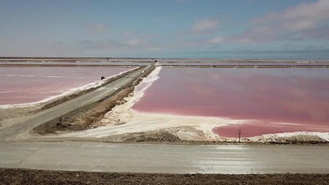 4K aerial drone video of salt works factory wide pink salty water evaporation ponds, in outskirts of coastal harbour town Walvis Bay, Namib Desert, Atlantic Ocean west coast, Namibia, southern Africa