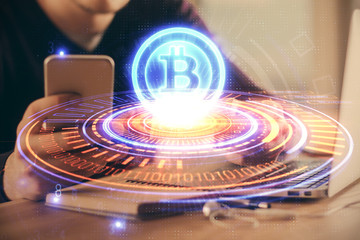 Double exposure of man's hands holding and using a phone and crypto currency blockchain theme drawing.