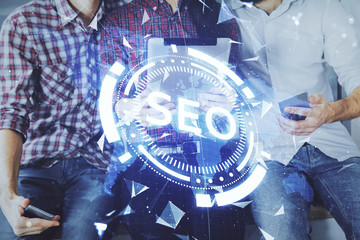 Double exposure of seo drawing and man and woman working together holding and using a mobile...