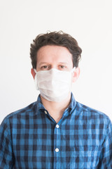 Man wearing a disposable face mask, to prevent the spread of the coronavirus