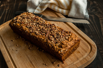 Fresh Baked Banana Bread Loaf with Knife and Cutting Board