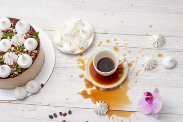 Spilled coffee on the table with cake