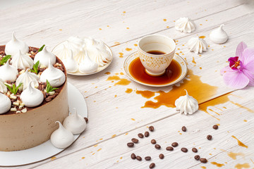 Spilled coffee on the table with cake