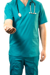 Sign of bribe or help. young male surgeon is standing in a blue suit with outstretched hand on a white background. Vertical frame