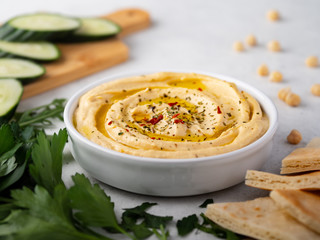 Hummus plate with cucumber slices and parsley