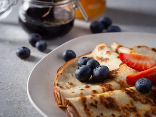 Pancakes with blueberries and strawberry