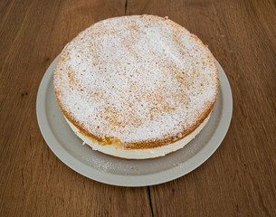 A complete, uncut delicious Cheesecake from a side view.