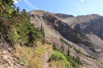 Fototapeta na wymiar Mark Malu trail goes under glacially carved face of American Fork Twin Peaks, Wasatch Range, Utah