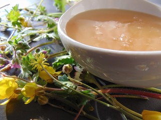  Honey and flowers. Thick natural honey in a bowl with wildflowers, close up.