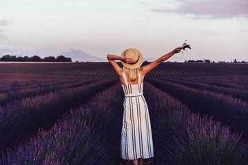 Unrecognizable woman enjoying evening in lavender field