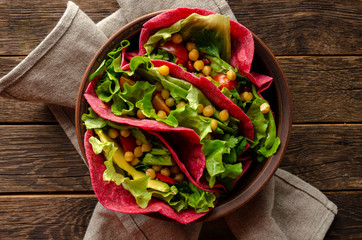 Vegan beetroot taco with salad, avocado, chickpea and vegetables