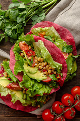Vegan beetroot taco with salad, avocado, chickpea and vegetables