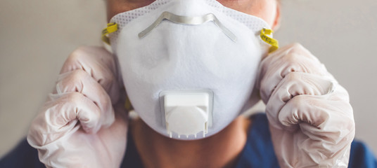 Doctor wearing protection face mask and latex gloves against coronavirus. Banner panorama medical...