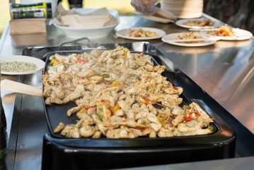 grilled chicken fajitas, prepared outdoors on a chrome table
