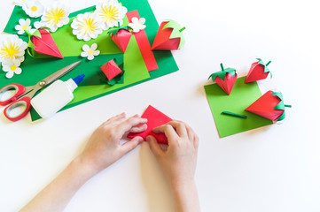 Origami strawberry made of craft paper. Learning at home. Kid diy.