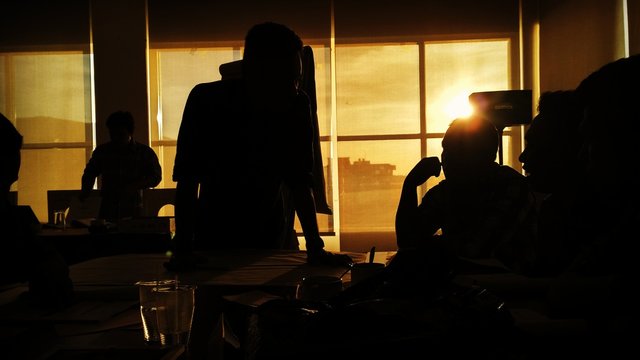 Silhouette People Working In Office During Sunset