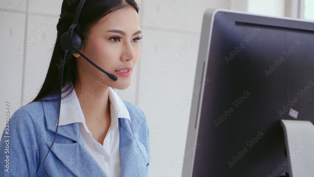 Aufkleber customer support agent or call center with headset works on desktop computer while supporting the cu