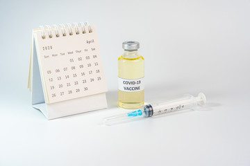 Studio shot of Covid-19 vaccine bottle and 2020 calendar 
