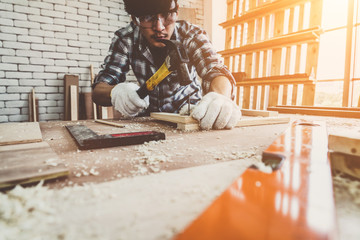 Carpenter working on wood craft at workshop to produce construction material or wooden furniture....