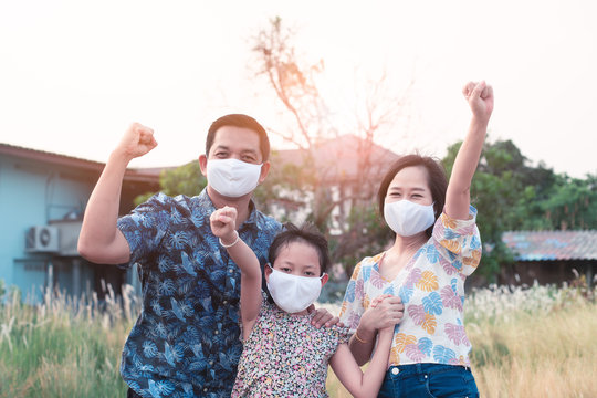 Power Of Family With Father Mother And Daughter Wearing Medical Face Mask For Protect 2019 - NCov , Covid 19 Or Corona Virus.Stay At Home Concept