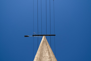 Under electric pole with clear blue sky at Oamaru, New Zealand.