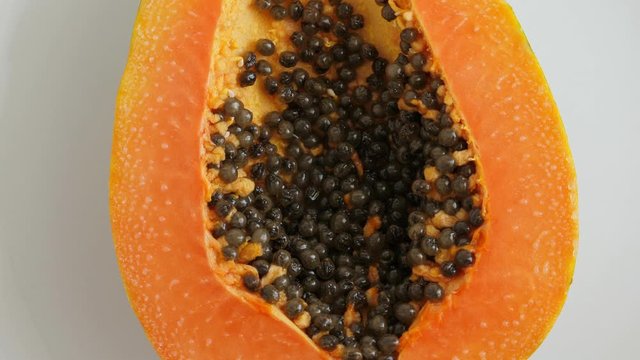 Top view of ripe half cut papaya. Rotate. Food background