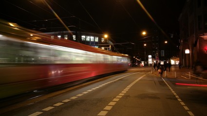 Fototapeta na wymiar Blurred Motion Of Train Moving On Road Against Sky At Night