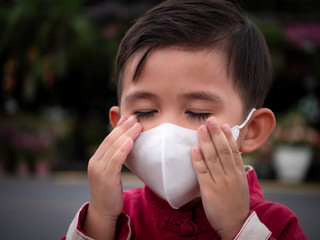 Portrait of asian boy wear mask trying to protect from coronavirus epidemic.