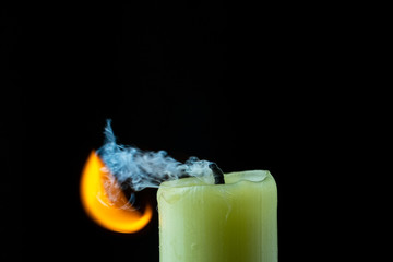the smoke of an extinguished candle on a black background close up