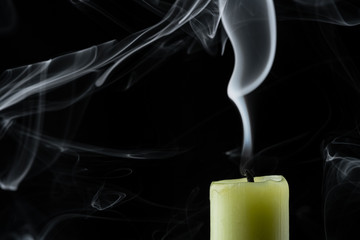 the smoke of an extinguished candle on a black background close up