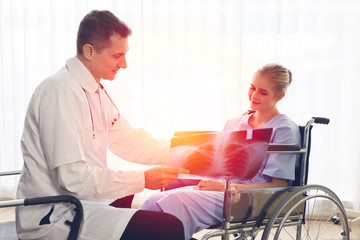 Fototapeta premium Professional doctor interview or talking with woman patient in hospital room or clinic, healthcare x-ray film diagnosis disease concept