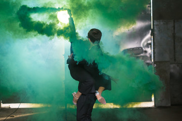 Pasadoble, latin solo dance and contemporary dance - Handsome man and woman dancing into smoke cloud.