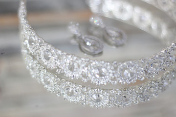 Wedding concept. Bride's hair accessory and earrings