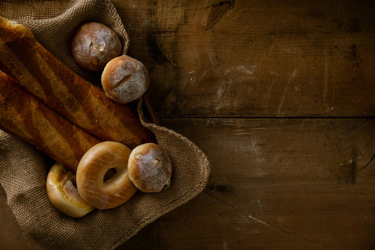 Breads,baguettes and bagels on burlap sack.
Delicious breads image. 
