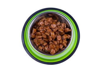 Canned food for cats or dogs in metal green bowl isolated on white background
