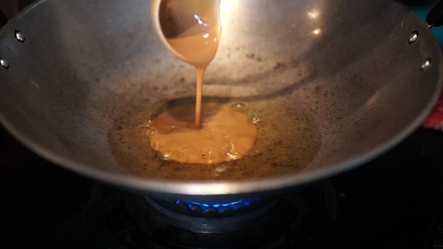 Process of making a homemade Cucur Jawa or Cucur Topi in a hot boiling oil.
