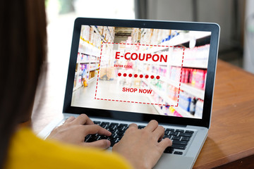 E-coupon, Grocery shopping online, Woman hand using laptop computer with discount coupon on screen, online shopping sale, digital marketing, retail business and technology, e commerce promotion