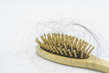 Close-up view of the hair loss on the wooden comb. Hair fall problem