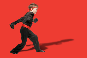 Young taekwondo fighter in black kimono practicing martial art